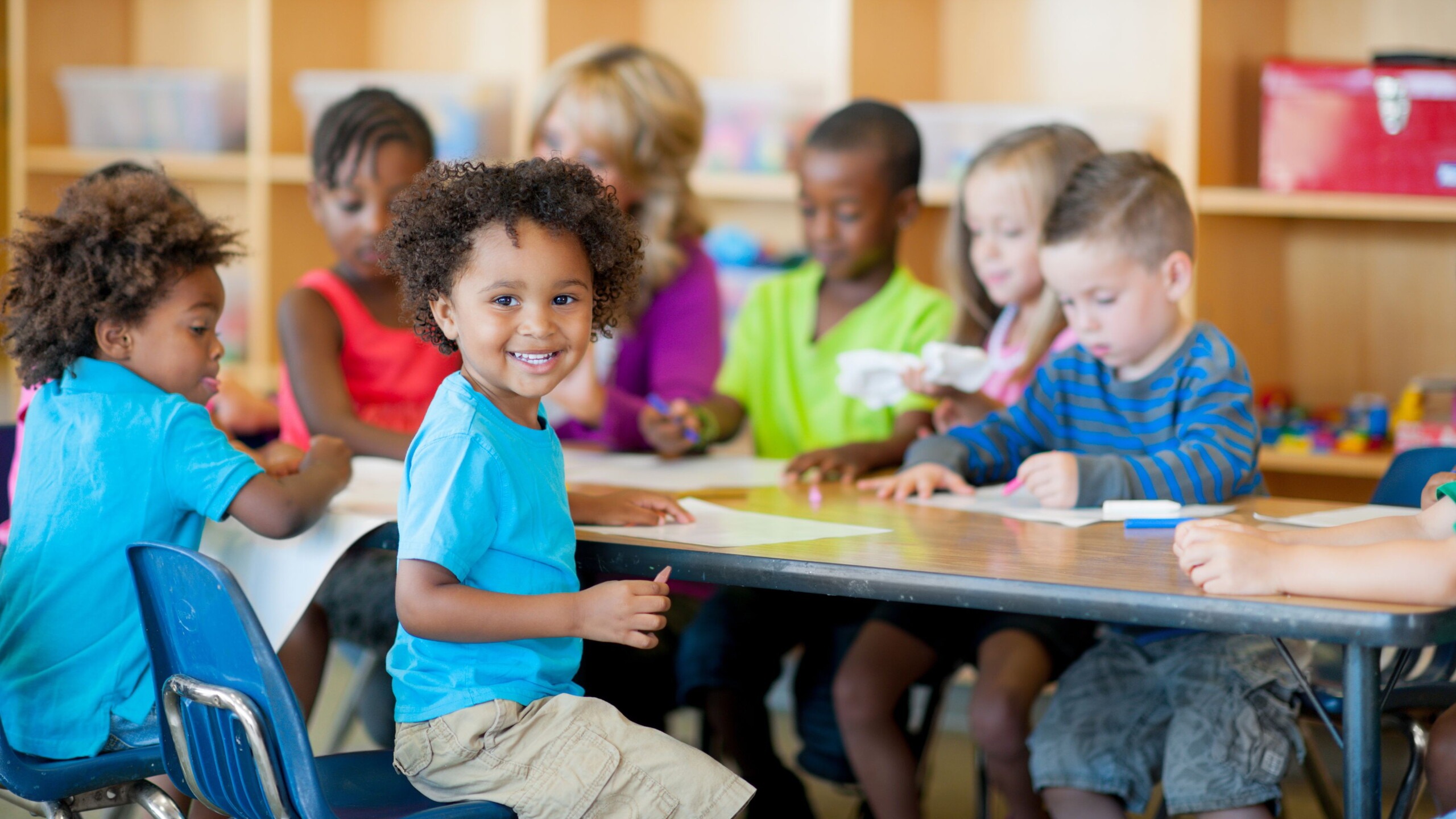 Groepje kinderen aan een tafel op de kinderopvang